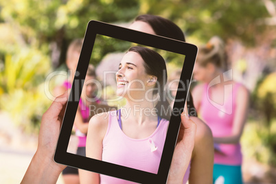 Composite image of close-up of hands holding digital tablet