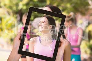 Composite image of close-up of hands holding digital tablet