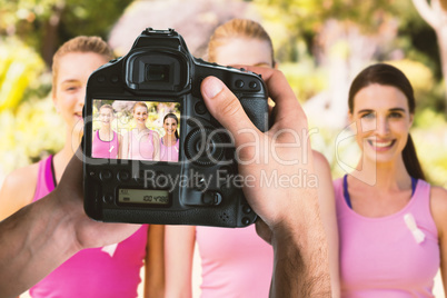 Composite image of cropped image of hands holding camera