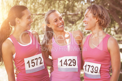 Smiling women running for breast cancer awareness