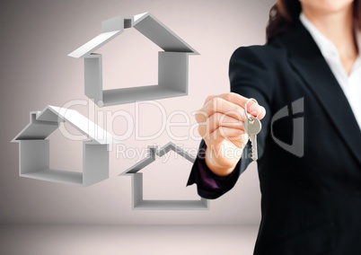 Woman Holding key with home icons in front of vignette