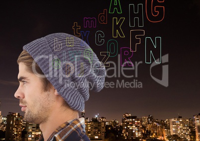 hipster in front ogf the city at night, thinking. colour letter coming up from head