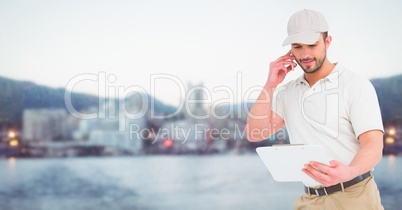 Delivery man on phone against blurry skyline