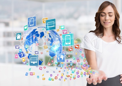 woman with hand spread of  with application icons coming up form it and earth  Blurred office backgr
