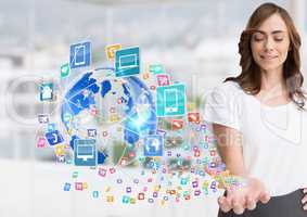 woman with hand spread of  with application icons coming up form it and earth  Blurred office backgr