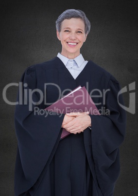 Female judge with book against grey wall