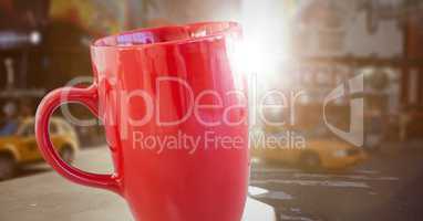 Red cup against blurry street with flares