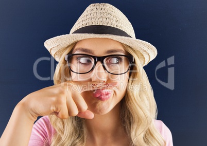 Millennials girl with mustache drawn on finger against blue background with white vignette