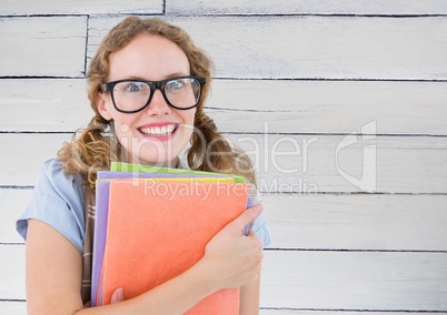 Nerd woman with books against white wood panel