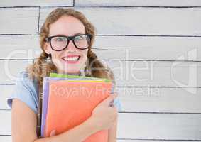 Nerd woman with books against white wood panel