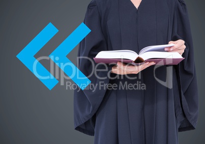 Judge mid section with book and blue arrow against grey background