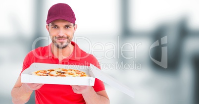 Delivery man with pizza against blurry office