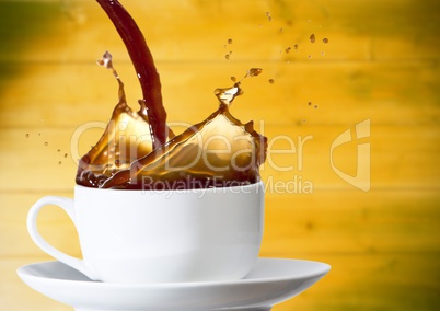 Coffee being poured into white cup against blurry yellow wood panel