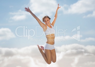 Woman jumping in air against blurry sky