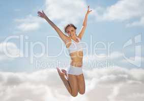 Woman jumping in air against blurry sky