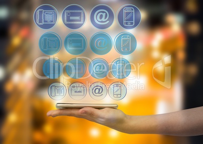 hand with phone with application blue icons panel over. Blurred city at night background
