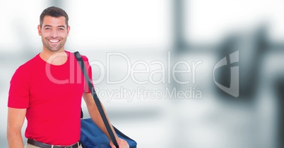 Delivery man with blue bag against blurry office