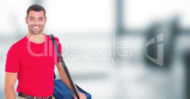 Delivery man with blue bag against blurry office