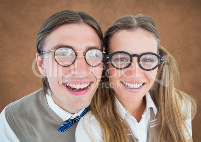 Close up of nerd couple against brown background with grunge overlay