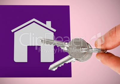 Hand Holding key with house icon in front of vignette