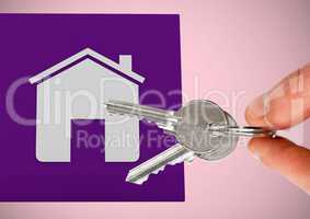 Hand Holding key with house icon in front of vignette