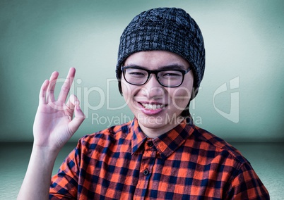 Millennial man making ok sign in green room