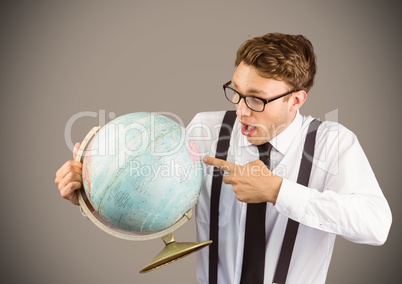 Nerd man pointing at globe against brown background
