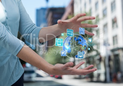 woman hands with earth with application icons between. She is in the street