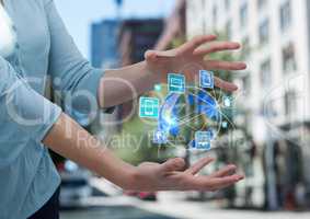 woman hands with earth with application icons between. She is in the street