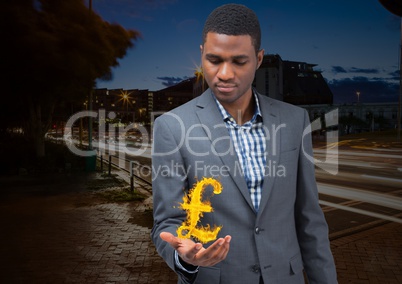 businessman with hand spread of  with pounds fire icon over in the city at night