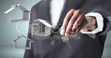 Hand Holding key with home icons in front of vignette