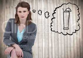 Business woman sitting and dreaming of cocktail against blurry wood panel