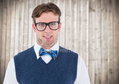 Nerd man in blue vest against blurry wood panel