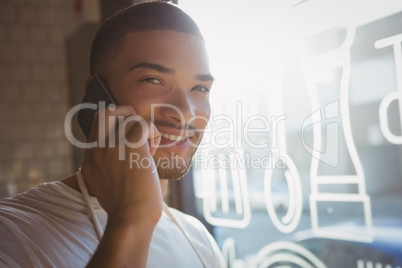 Portrait of waiter talking on mobile phone