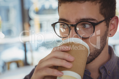 Close-up of man drinking coffee