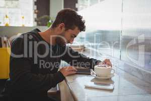 Man using tablet in cafe