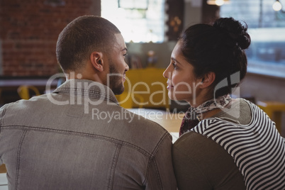 Couple looking each other at counter