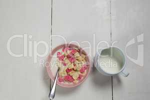 Bowl of honeycomb cereal and milk on wooden table