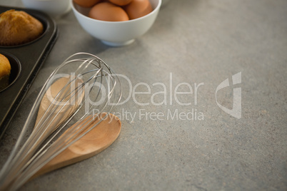 Wire whisk by egg and muffin tin