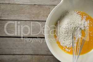 Flour on egg yolk in container