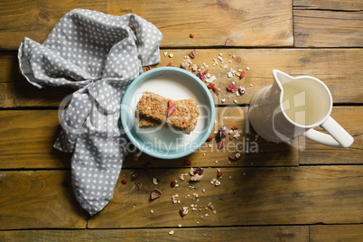 Granola bar and milk in bowl