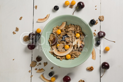 Bowl of wheat flakes with blueberry and golden berry
