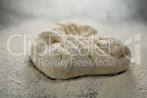 Close up of flour on kneaded dough