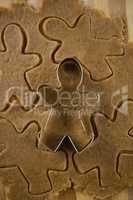 Gingerbread man pastry cutter on dough