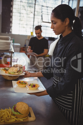 Waitress holding plates with food in cafe