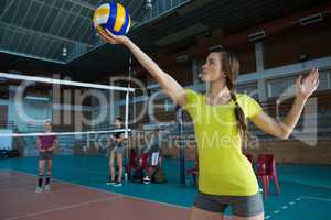 Female volleyball player holding ball
