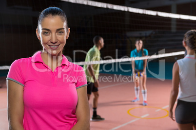 Portrait of smiling volleyball player by teammates