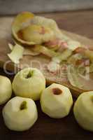 High angle view of fresh apples by peels on cutting board