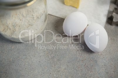 High angle view of eggs by flour in glass jar