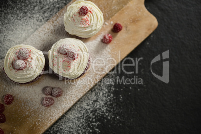 Overhead view of cupcakes on cutting board